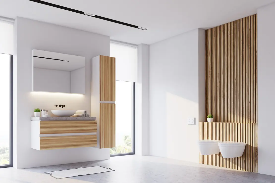 Aseo con piso de microcemento gris y componentes de madera Aseo con piso de microcemento gris y componentes de madera